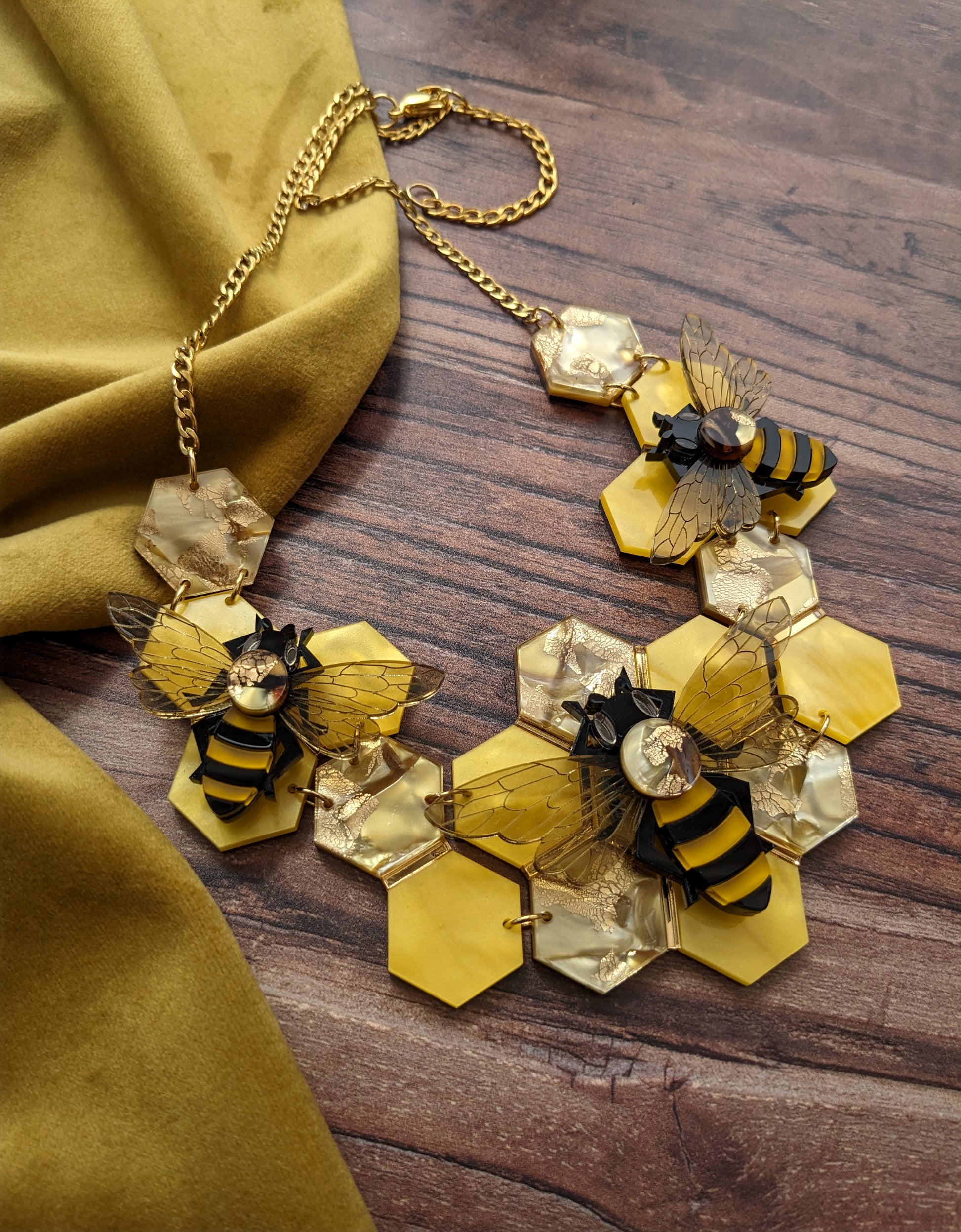 Handmade laser cut acrylic honey bee necklace featuring recycled acrylic 