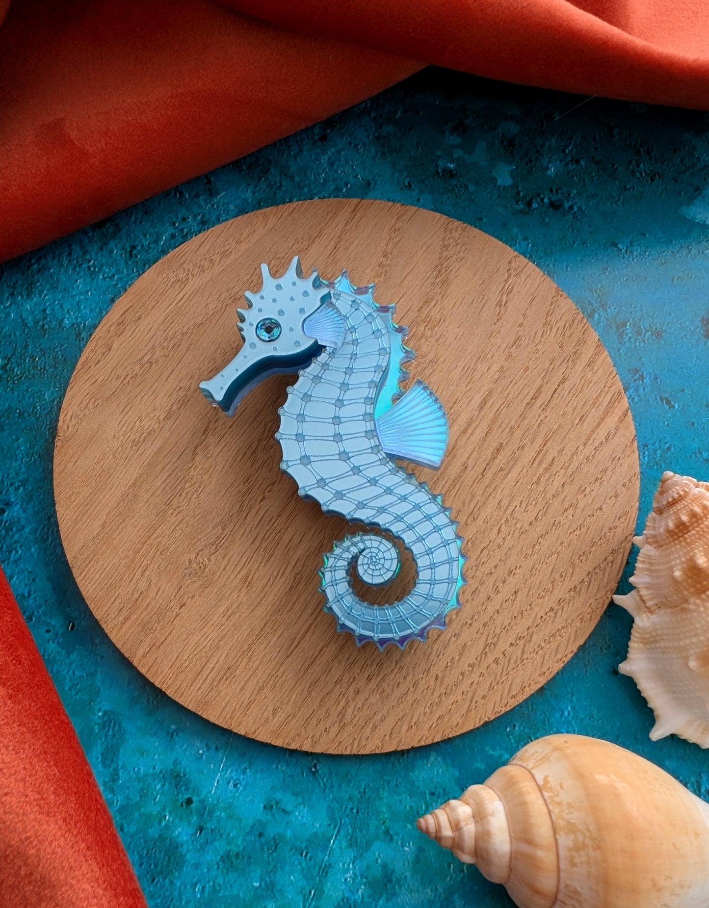 a handmade acrylic blue seahorse brooch