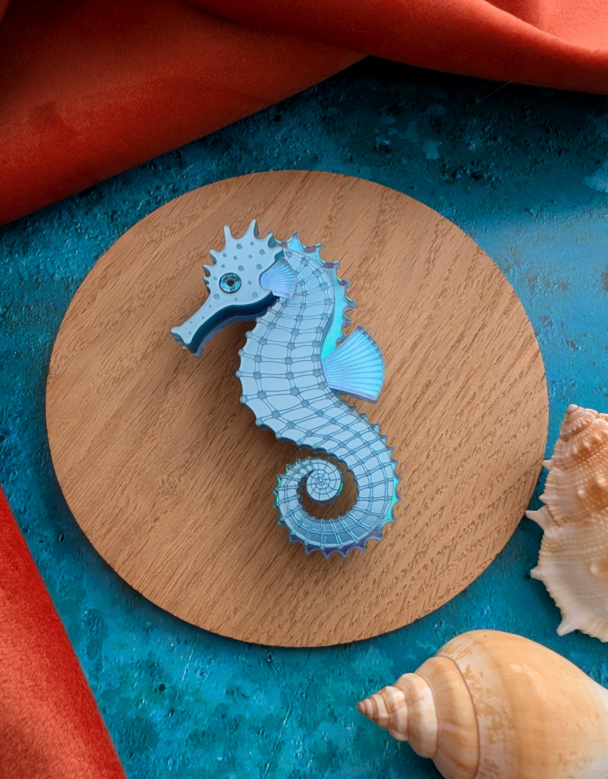 a handmade acrylic blue seahorse brooch