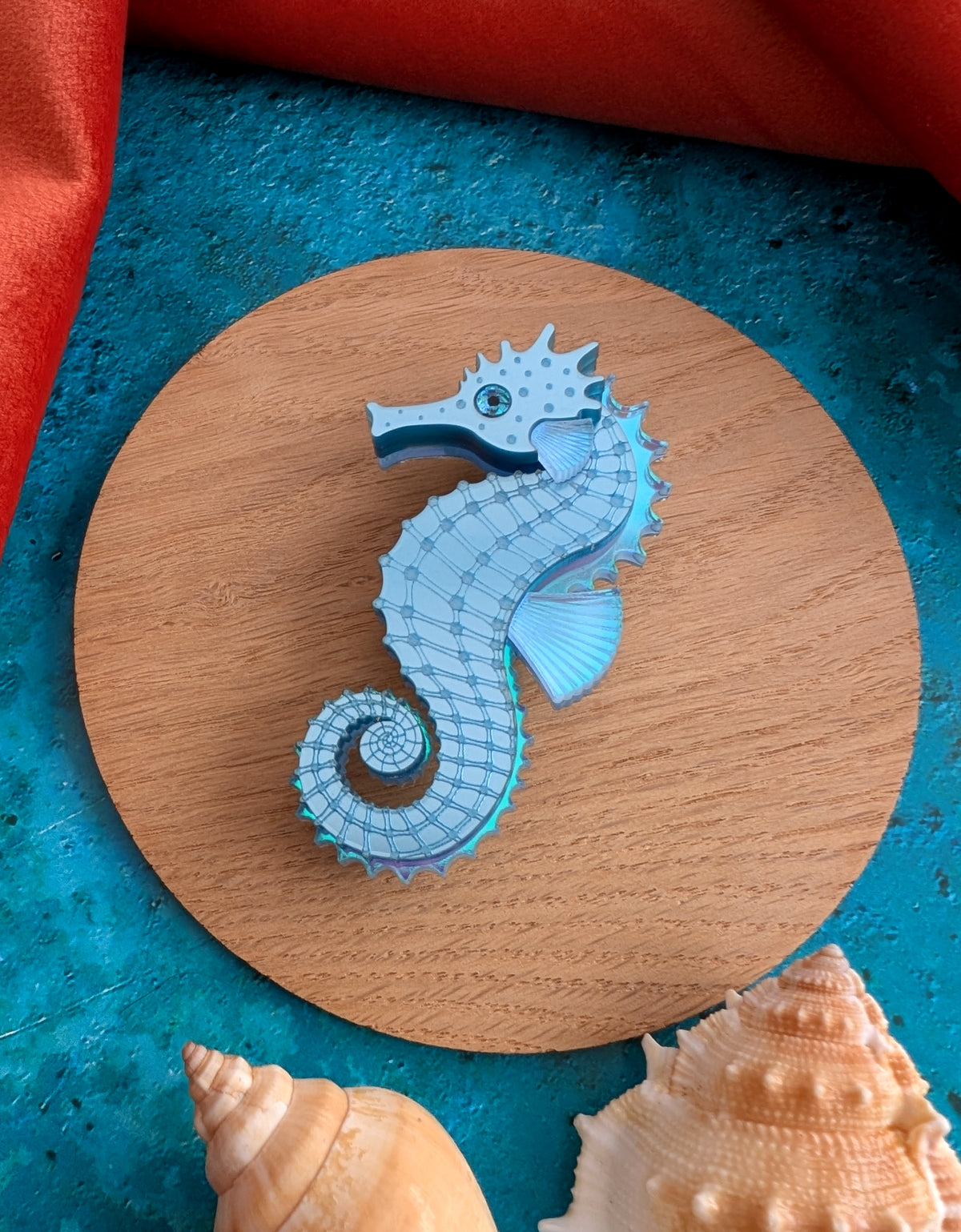 a handmade acrylic blue seahorse brooch
