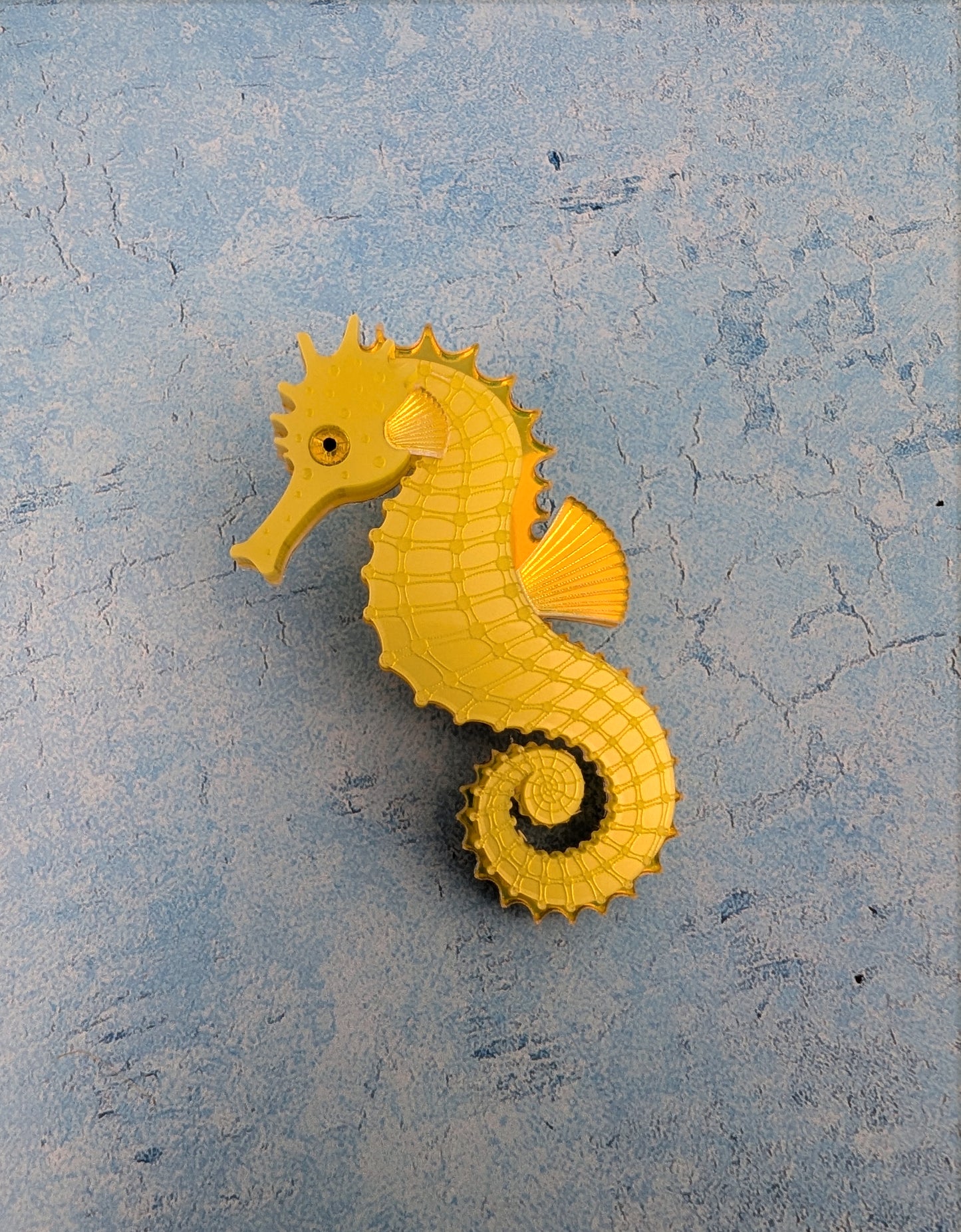 a handmade acrylic yellow seahorse brooch