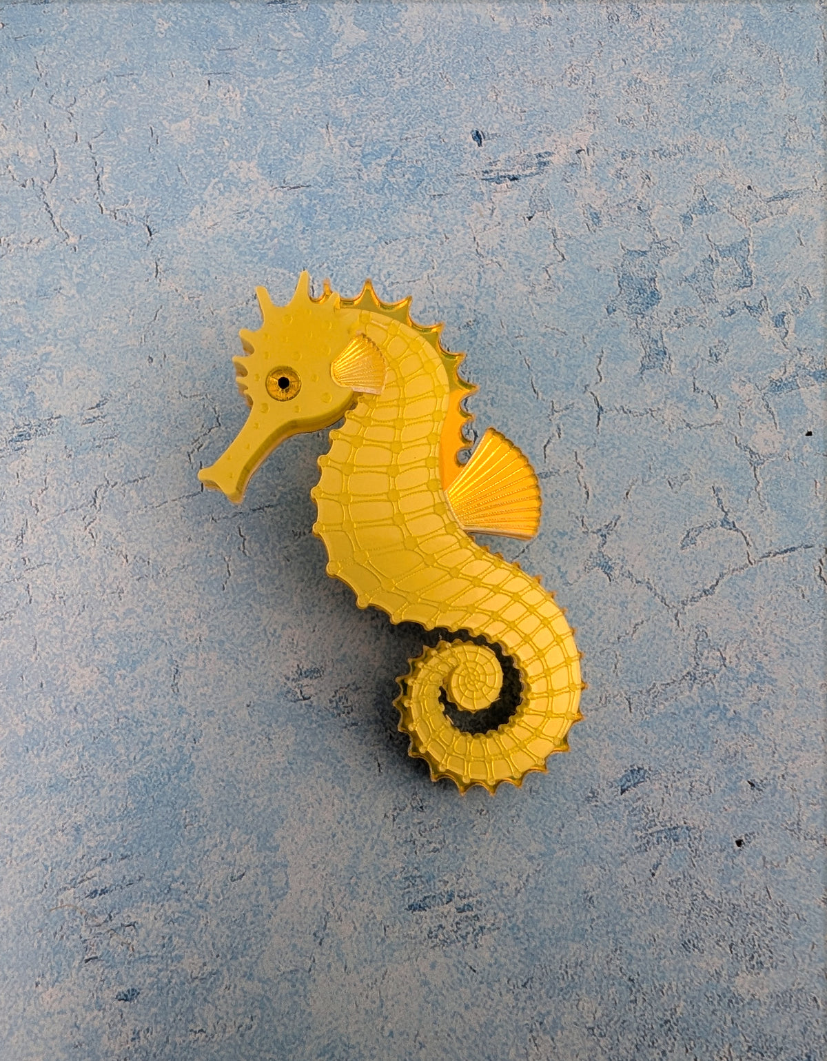 a handmade acrylic yellow seahorse brooch