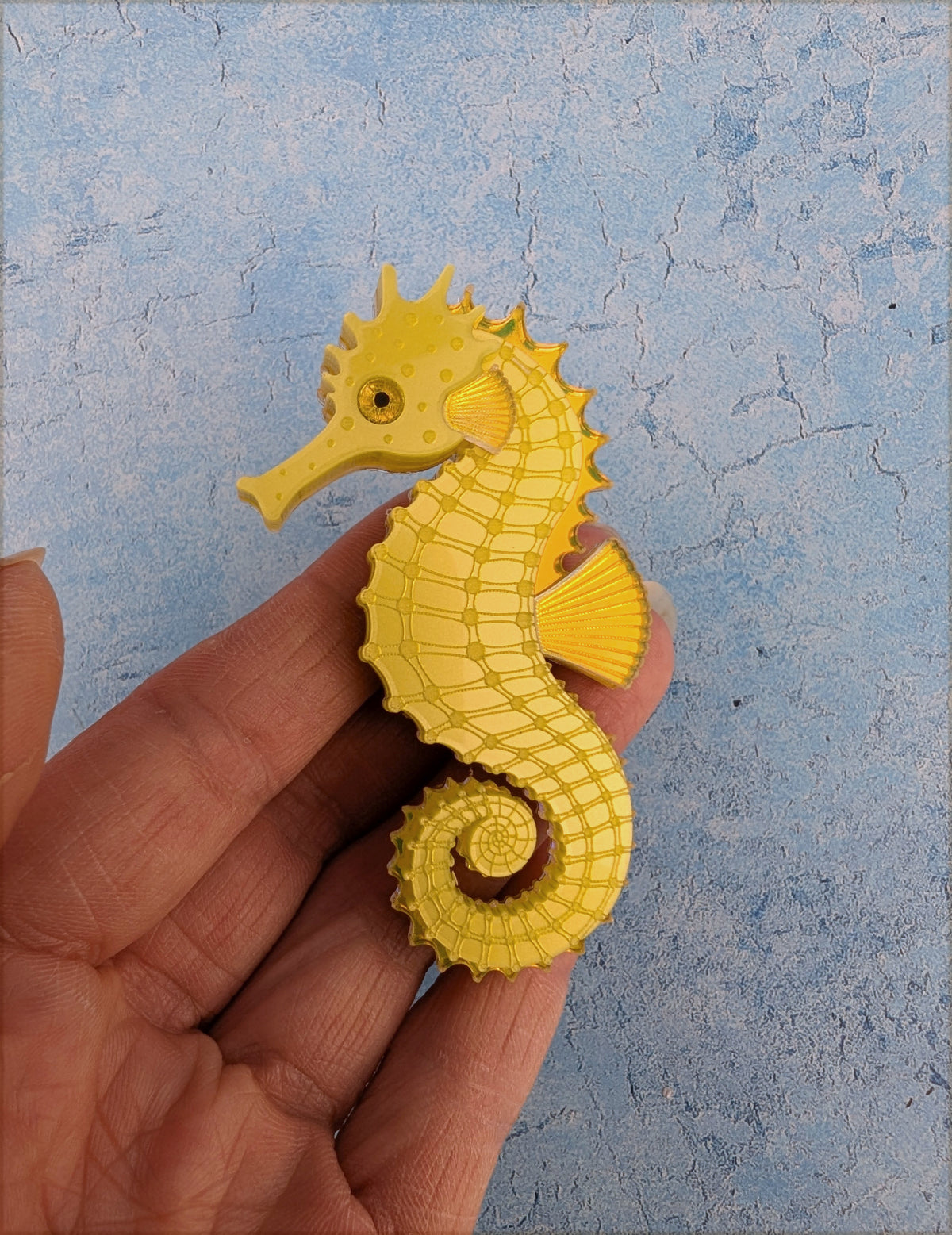 a handmade acrylic yellow seahorse brooch